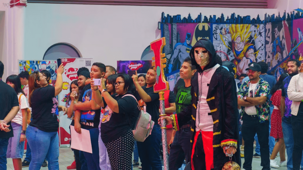 Anime convention visitors and cosplay attendees entering an event.
