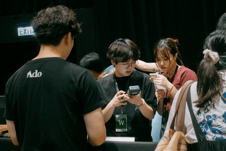Visitors checking admission tickets before entering an event.